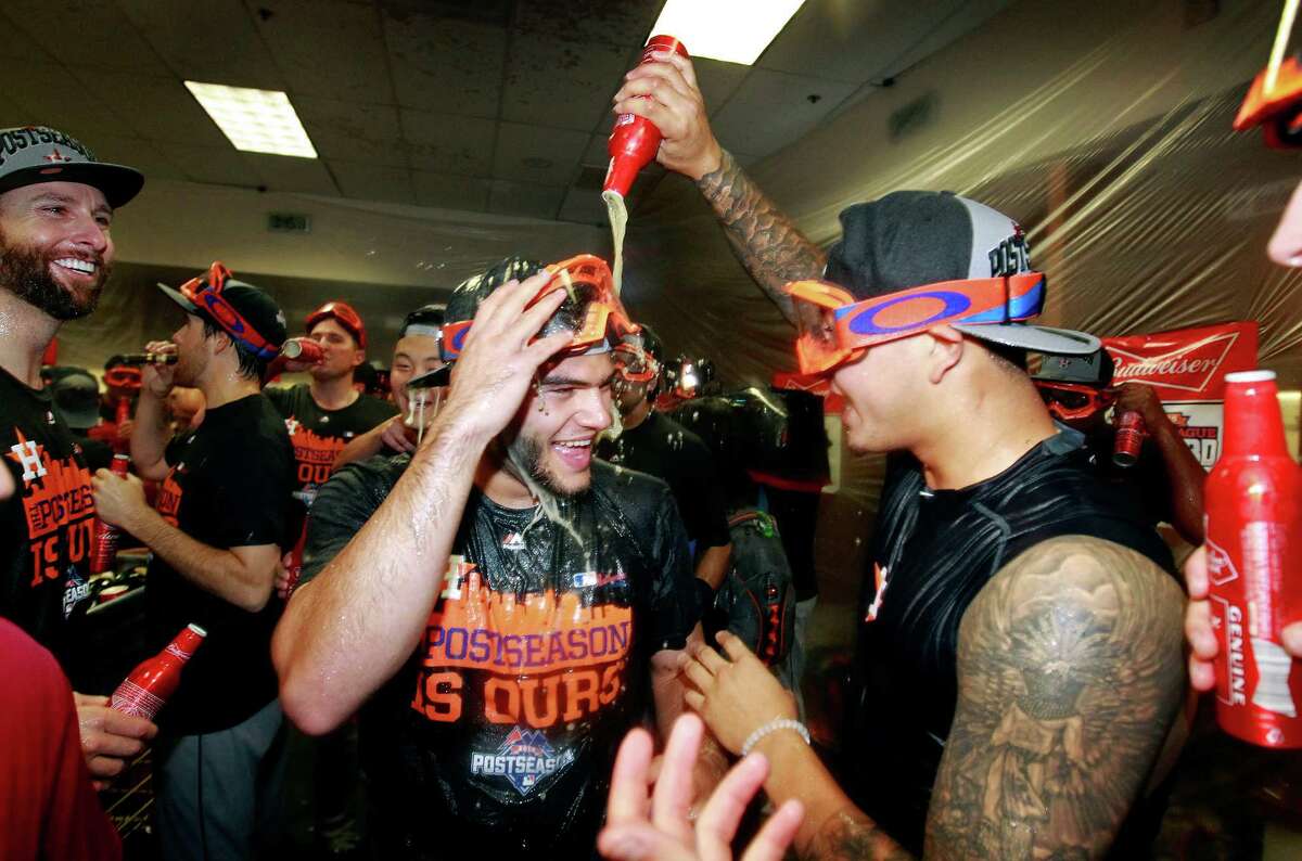 Houston Astros’ Lance McCullers and Vincent Velasquez celebrate their AL Wild Card playoff berth despite losing 5-3 to the Arizona Diamondbacks during a baseball game, Sunday, Oct. 4, 2015, in Phoenix.