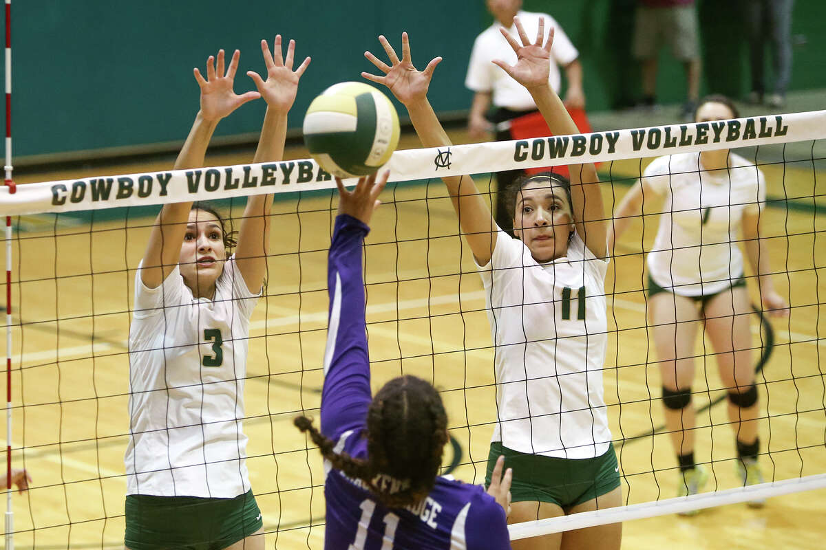 McCollum’s Bryana Rich (left) and Victoria Yzaguirre to up to block a shot by Brackenridge’s Skyler Reyna during their match at McCollum on Tuesday, Sept. 15, 2015.