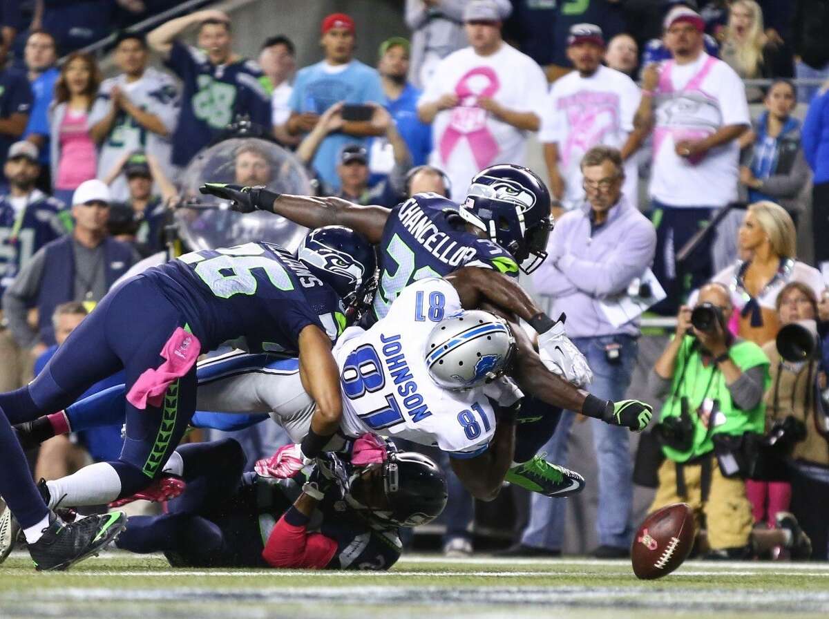 Seahawks strong safety Kam Chancellor forces a fumble from Detroit Lions receiver Calvin Johnson at the end of the Hawks' 13-10 victory on Monday, Oct. 5, 2015. (Joshua Trujillo/seattlepi.com)