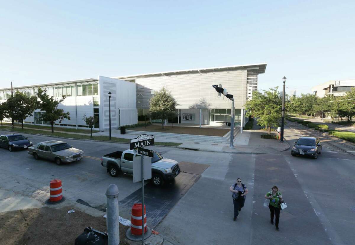 Pedestrians walk past the Midtown Arts and Theater Center Houston, or MATCH, Friday, Oct. 2, 2015, in Houston.