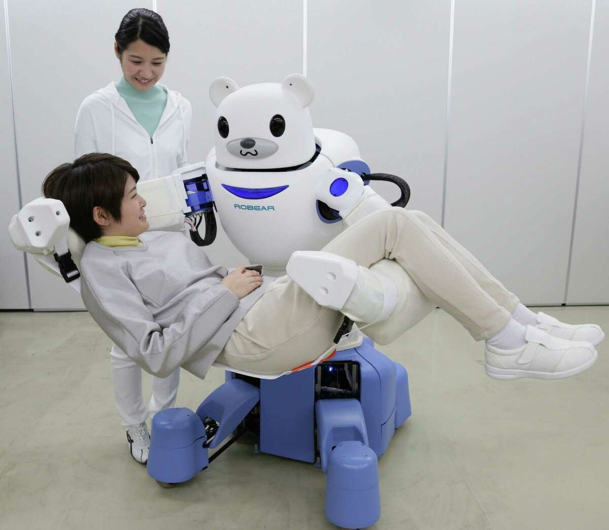 Judson ISD teacher Joseph Jacobson says anyone curious about the future of robotics should look to Japan. This picture taken on Feb. 23, 2015, shows a polar bear robot "Robear" lifting a woman for a demonstration in Nagoya, central Japan. The "Robear," developed by Riken Institute and Sumitomo Riko, has a polar cub-like face with big doey eyes, but packs enough power to transfer frail patients from a wheelchair to a bed or a bath.