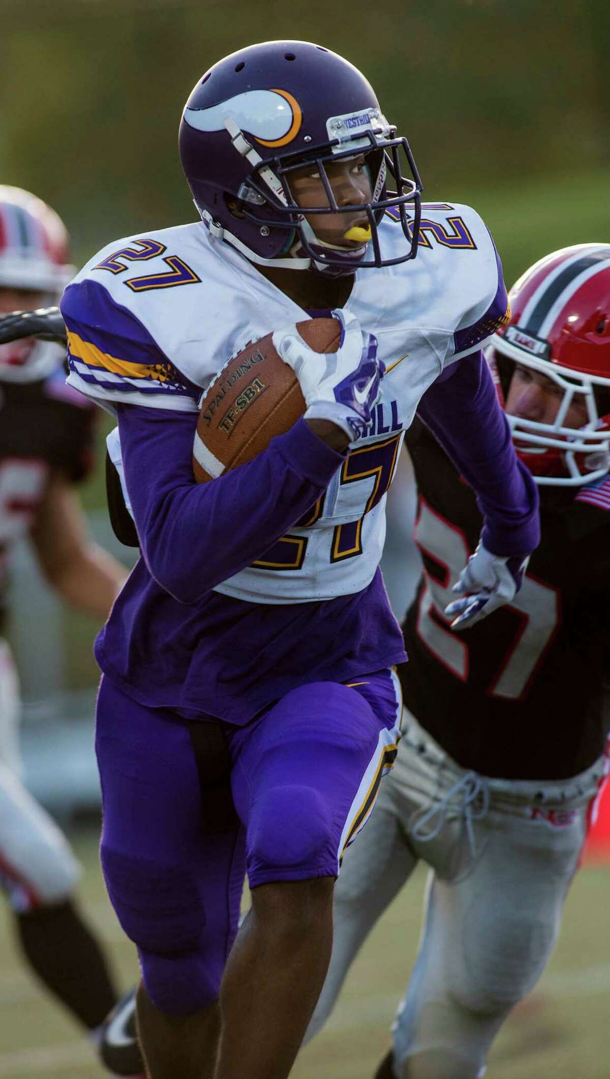 Westhill High School’s Everett Charles Brown runs with the ball against New Canaan High School on Monday.