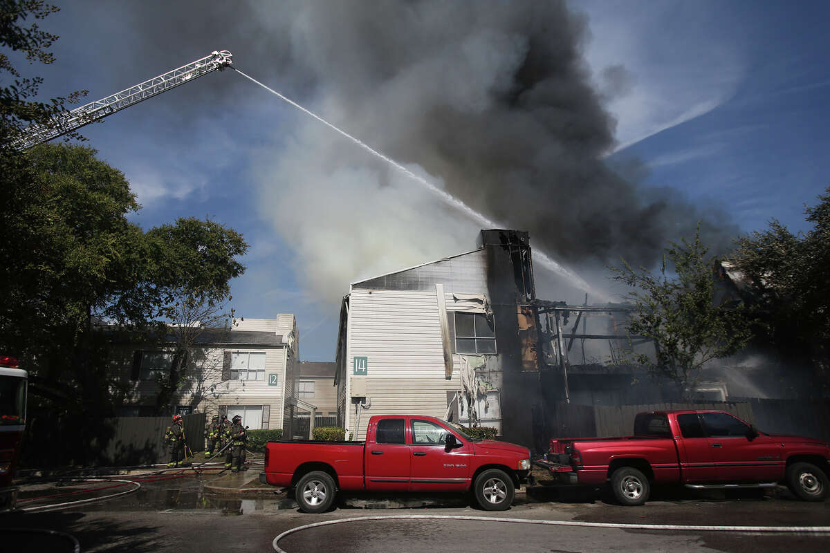 San Antonio firefighters douse flames Tuesday October 6, 2015 at the Fox Run Apartments on the 10,000 block of Broadway. the Two alarm fire started shortly before 11:00 am.