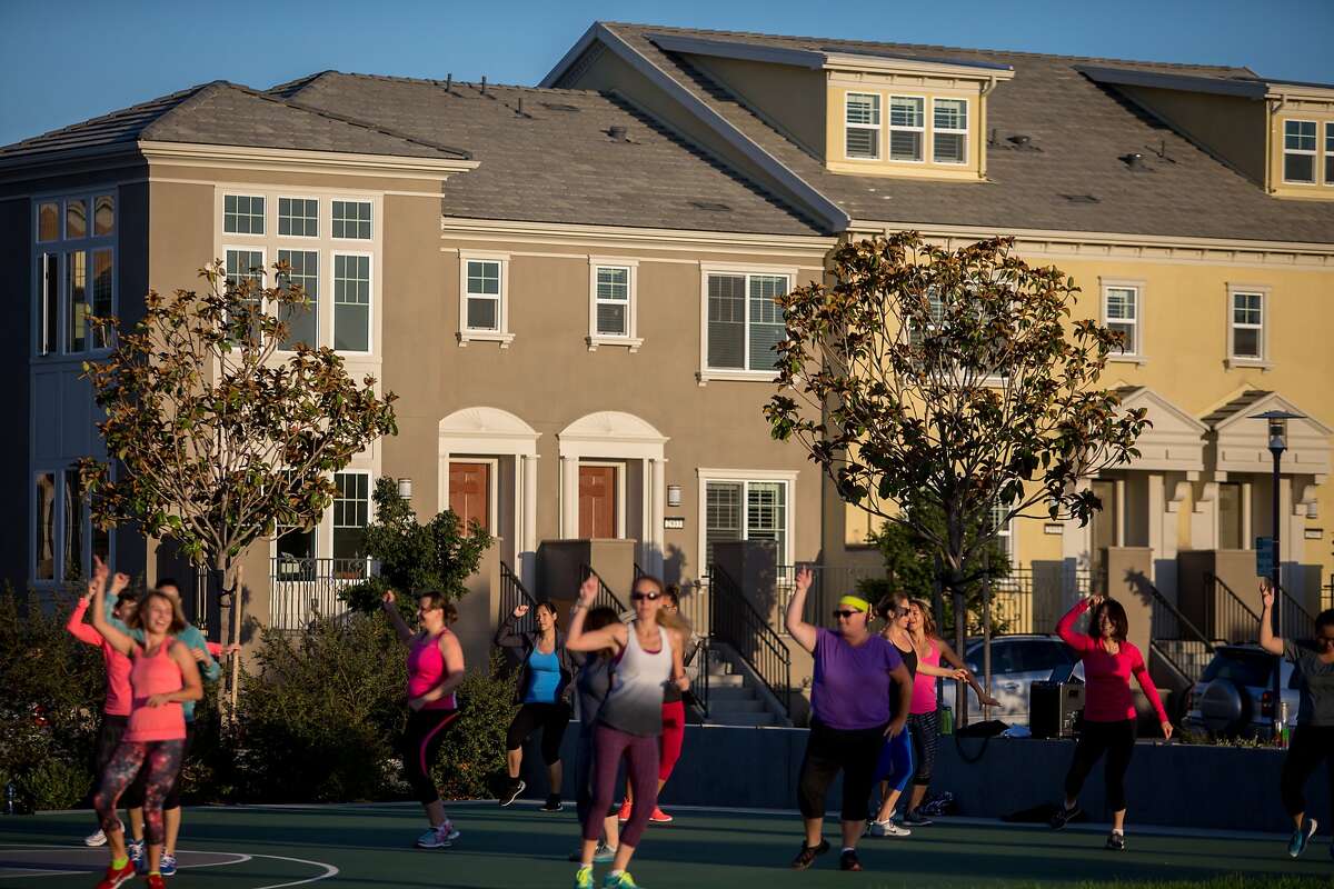 A group of women exercise to the sounds of samba and salsa in one of the many parks in the emerging Bay Meadows infill community that has replaced the old racetrack in San Mateo on Monday, Oct. 5, 2015 in San Mateo, Calif.