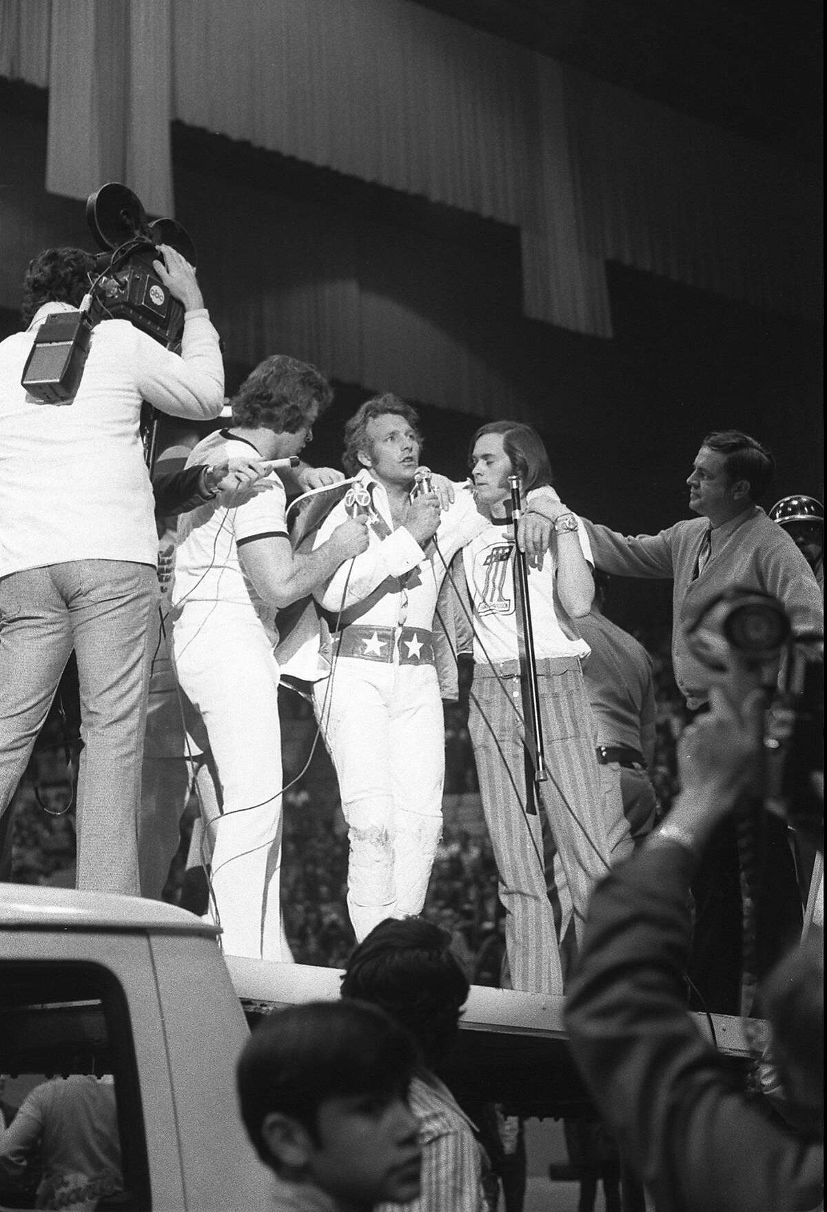 Evel Knievel addresses the crowd at the Cow Palace after making his record jump.