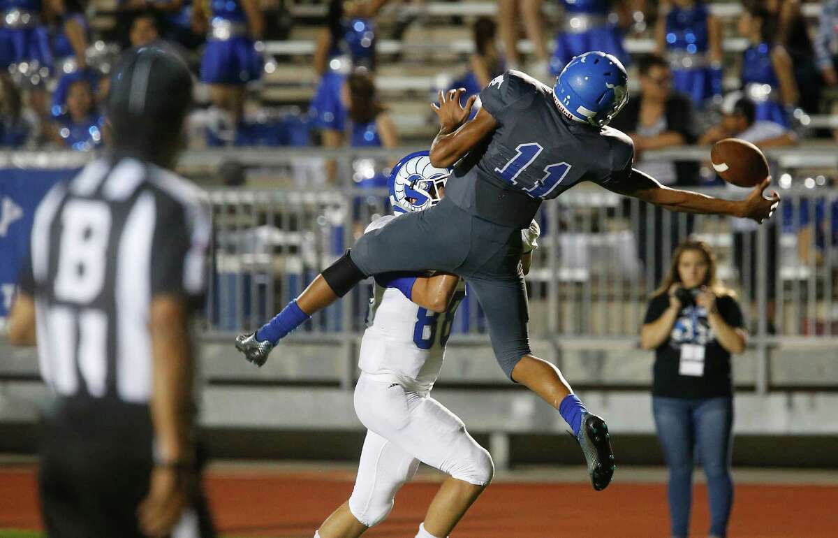 John Jay’s Moses Reynolds (11) nearly picks off a pass against Del Rio’s Gaston Flores (88) during their game at Gustafson Stadium on Friday, Sept. 11, 2015.