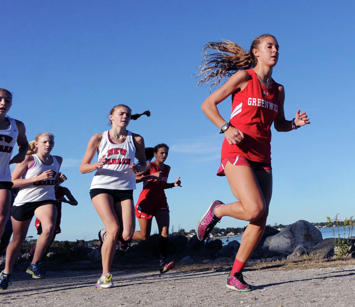 Sabrina Thurber of Greenwich, right, in action during a girls high school cross country meet at Greenwich Point Tuesday. Thurber finished the meet in first place.