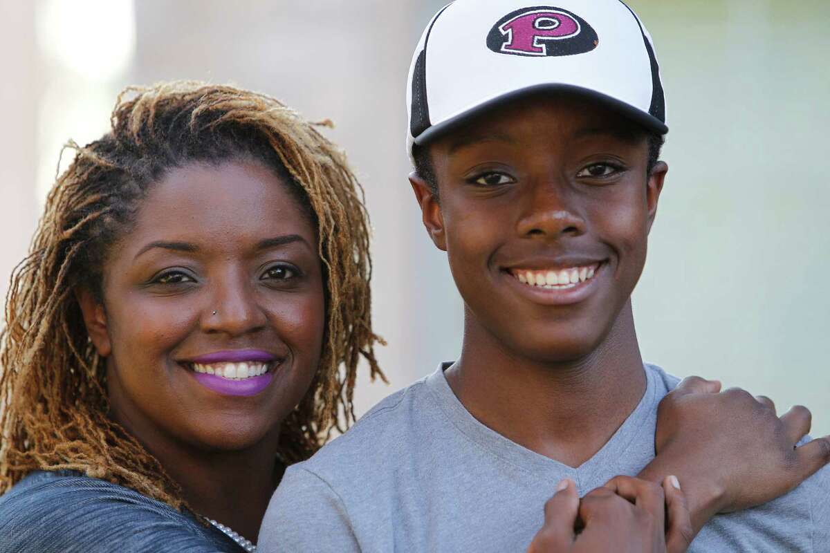 Ronie Dean-Burren is very proud of her Pearland High School freshman son, Coby Burren Tuesday, Oct. 6, 2015, in Pearland. He discovered a major mistake in a textbook being used at his school. ( Steve Gonzales / Houston Chronicle )
