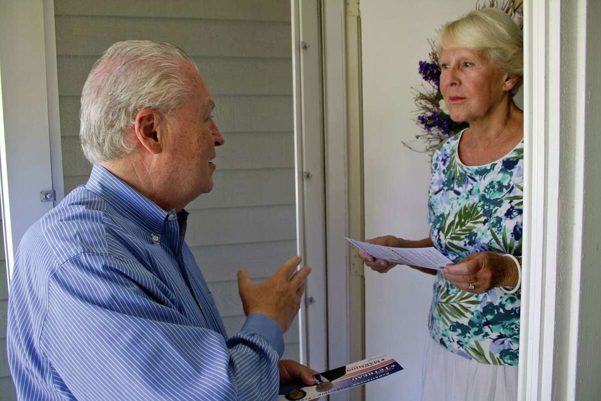 First Selectman Mike Tetreau talks with a resident while campaigning for re-election to a second term.