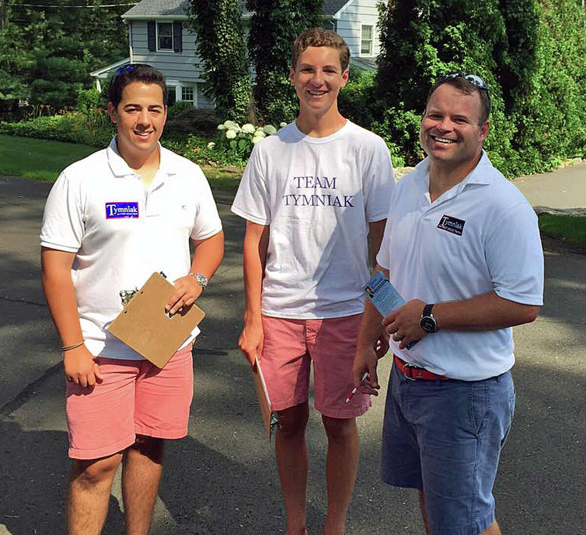 Republican first selectman candidate Chris Tymniak, far right, hits the campaign trail with volunteers Jack Elsas, left, and Damian Chessare, right.