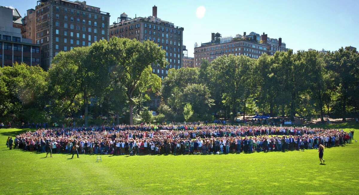 A crowd gather in Central Park to form a human peace sign to remember John Lennon and attempt a Guinness world record, Tuesday, Oct. 6, 2015, in New York. Thousands of people joined Yoko Ono and tried to set a world record for largest group of human bodies forming a peace sign. The record attempt to honor Ono's husband, John Lennon, didn't succeed. Lennon would have turned 75 on Friday. (AP Photo/Bebeto Matthews) ORG XMIT: NYBM103