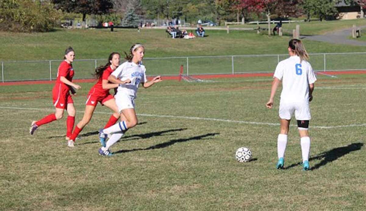 Shepaug's Caroline Kelly (10) and Noelia Aguirre (6) work the ball against Wamogo.