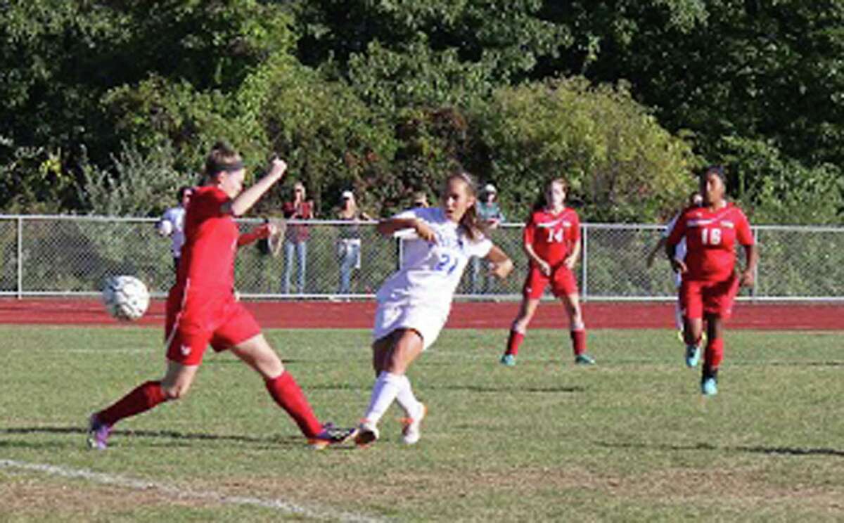 Nathalie Diller (21) unleashes a shot during Tuesday's 2-2 tie against Wamogo.