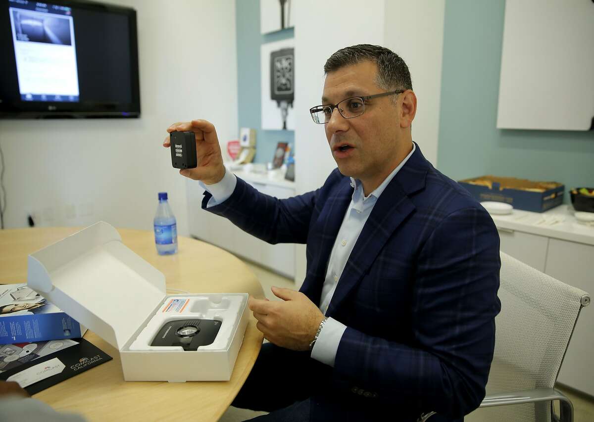 Daniel Herscovici explains a garage door security system integrated into the Xfinity Home App at the Comcast offices in San Francisco, California, on Wednesday, Oct. 7, 2015.