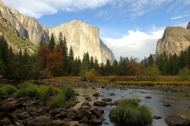 Classic fall photo of Yosemite Valley, with Merced River in foreground