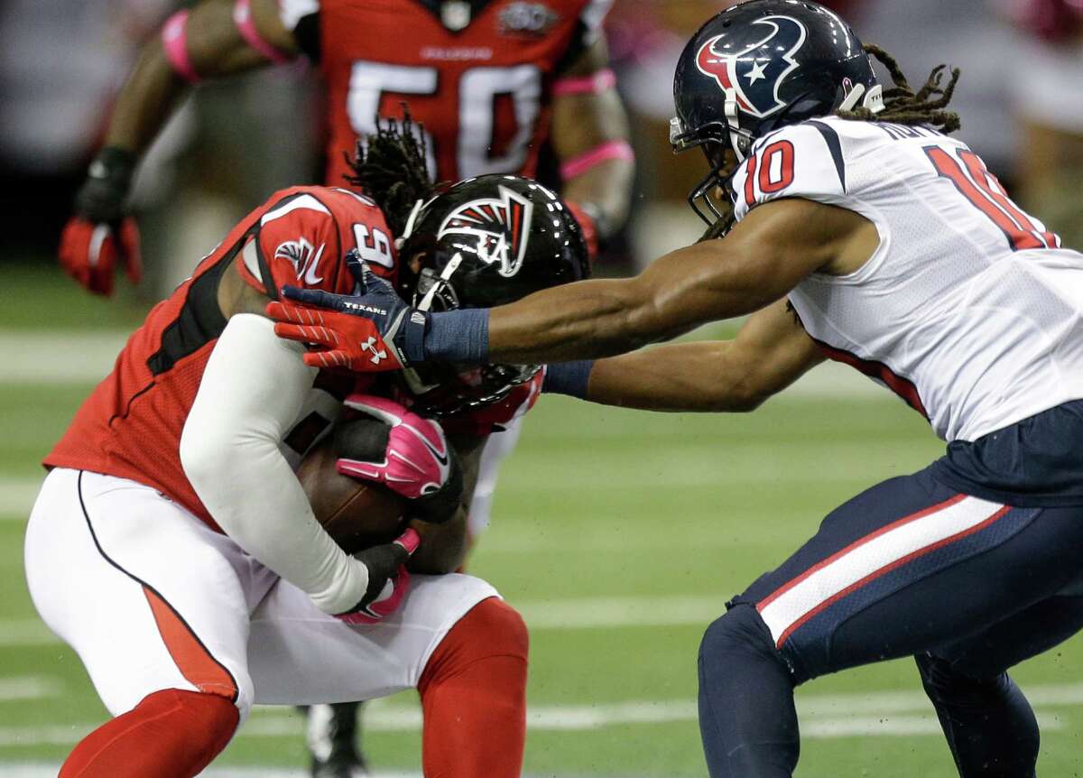 Falcons defensive tackle Jonathan Babineaux (95) comes down with an interception on a pass intended for Texans wide receiver DeAndre Hopkins.