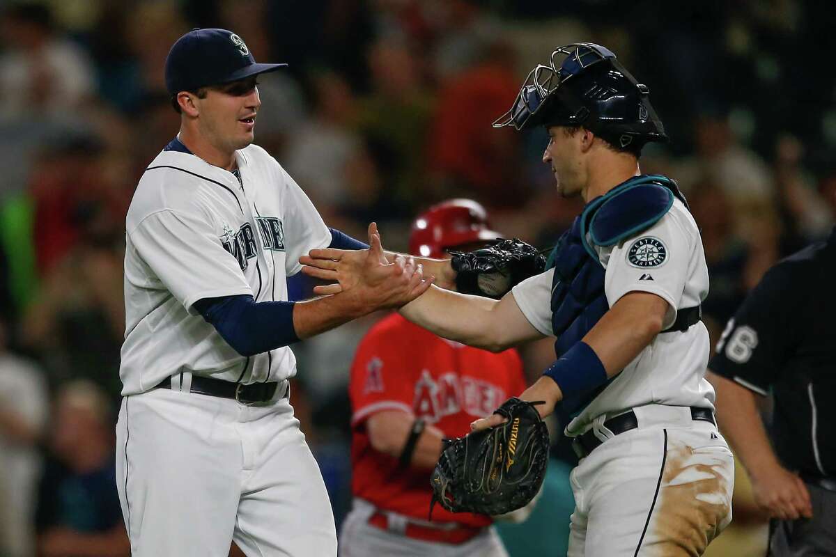 SEATTLE, WA - JULY 09: Closing pitcher Carson Smith #39 of the Seattle Mariners is congratulated by catcher Mike Zunino #3 after defeating the Los Angeles Angels of Anaheim 7-2 at Safeco Field on July 9, 2015 in Seattle, Washington.