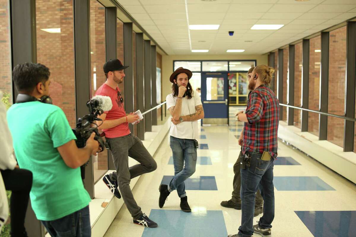 (L to R) Brent Stiefel (producer), Miles Joris-Peyrafitte (Director), Sean Patrick Burke (1st AD/Producer), Bhawin Suchak (in foreground). Discussing a complex dolly shot in the hallway of Albany High School. (Photo courtesy Youth FX)