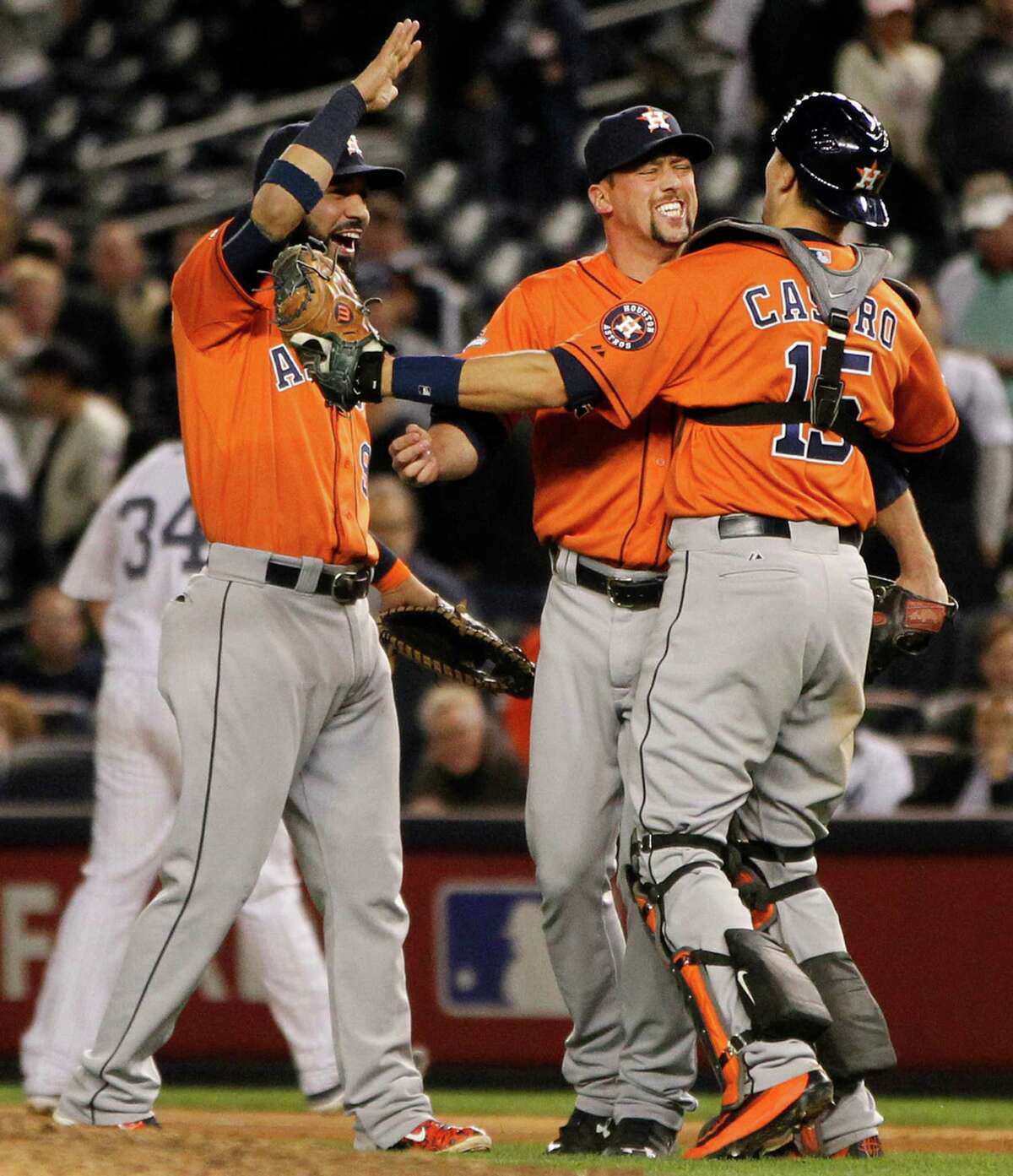 Houston Astros closer Luke Gregerson, center, celebrates the Astros 3-0 win over the New York Yankees with first baseman Marwin Gonzalez and catcher Jason Castro in the American League Wild Card game at Yankee Stadium on Tuesday, Oct. 6, 2015, in New York. ( Karen Warren / Houston Chronicle )