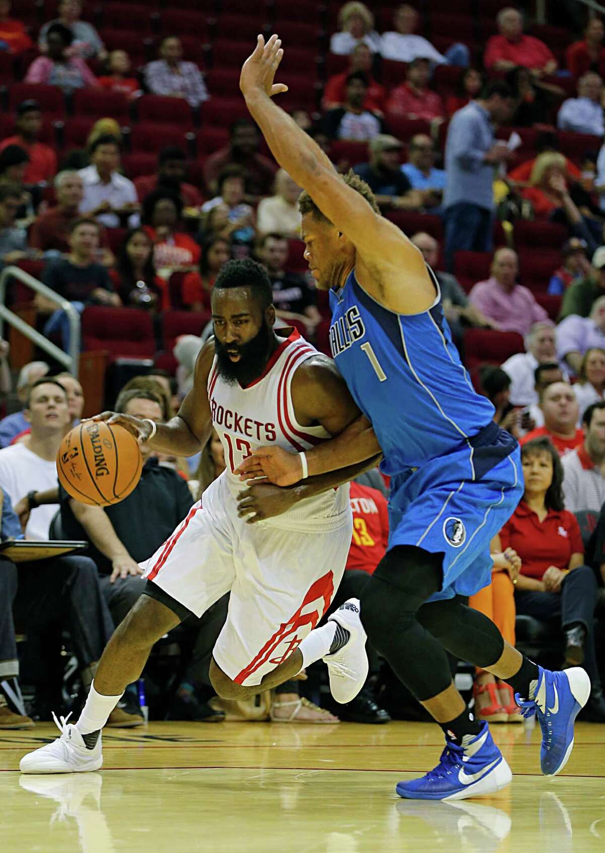 James Harden played so long and hard in the first half Wednesday night against the likes of the Mavericks' Justin Anderson, right, that it was more like the regular season instead of the second preseason game in as many nights.