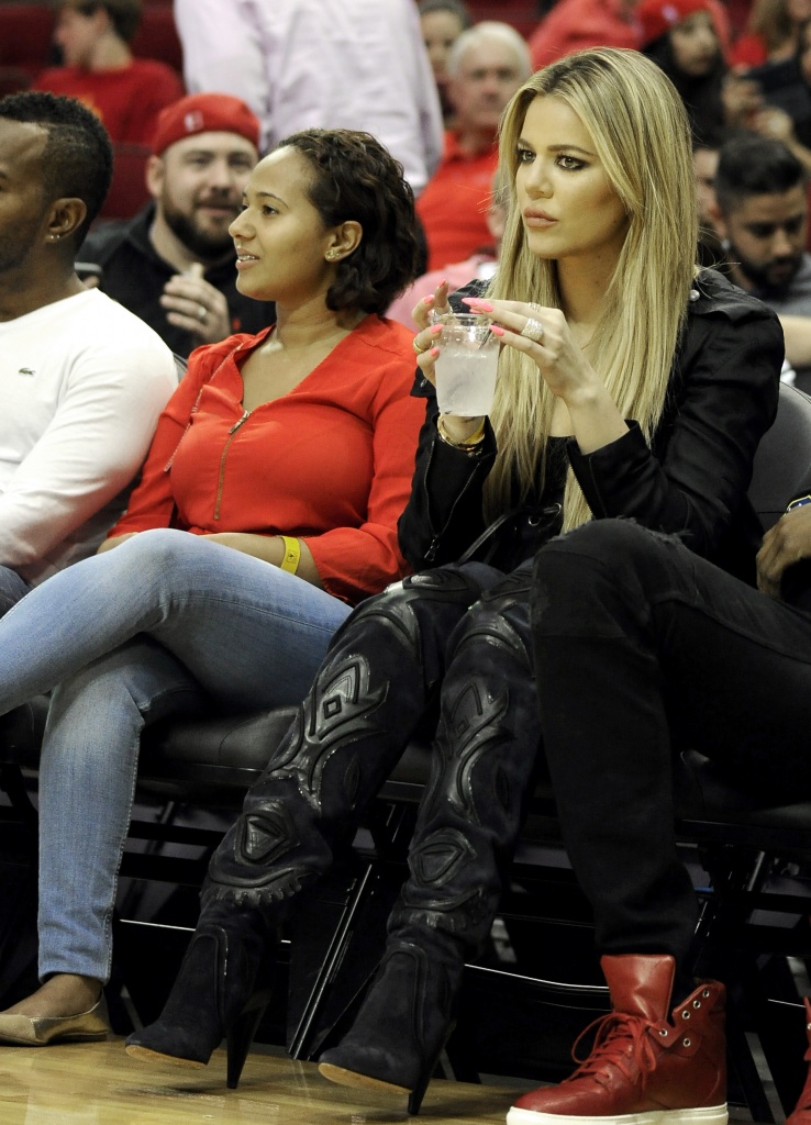 Kylie Jenner, left, and Travis Scott walks to their seats during the second  half in Game 2 of a first-round NBA basketball playoff series between the  Houston Rockets and the Minnesota Timberwolves