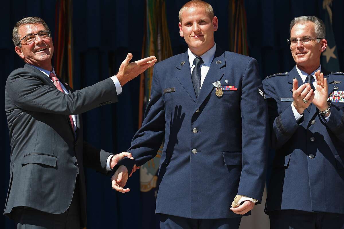 U.S. Air Force Airman 1st Class Spencer Stone (center) is congratulated by U.S. Defense Secretary Ashton Carter (left) and Vice Chairman of the Joint Chiefs of Staff Gen. Paul Selva during an awards ceremony for Stone and two other men who helped stop a gunman on a Paris-bound train last month at the Pentagon September 17, 2015 in Arlington, Virginia. Stone received the Airman's Medal and the Purple Heart medal, Army Specialist Alek Skarlatos received the Soldier's Medal and Anthony Sadler received the Defense Department Medal for Valor. The three men helped overpower gunman Ayoub El-Khazzani, 25, after he opened fire on a Thalys train traveling from Amsterdam to Paris on August 21.