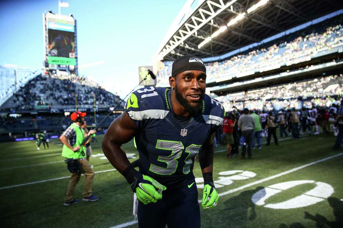 Seattle strong safety Kam Chancellor runs off the field after helping the Seahawks defense shut out the Chicago Bears at CenturyLink Field. Photographed on Sunday, Sept. 27, 2015.