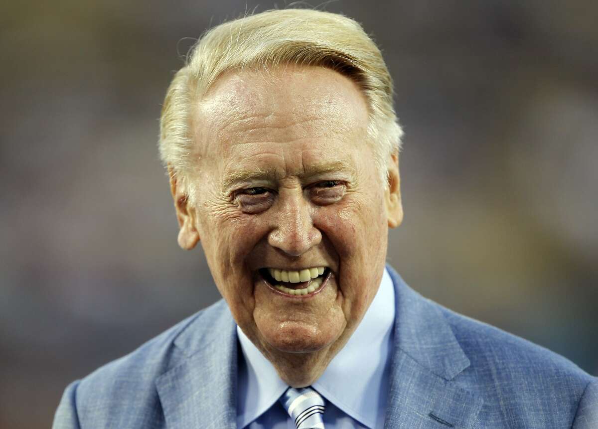 Los Angeles Dodgers broadcaster Vin Scully is honored before a baseball game against the Arizona Diamondbacks in Los Angeles, Wednesday, Sept. 23, 2015. Scully was given a Guinness World Records certificate for the longest career as a sports broadcaster for a single team, and the team honored him with a bobble head for all of the fans in attendance. (AP Photo/Alex Gallardo)