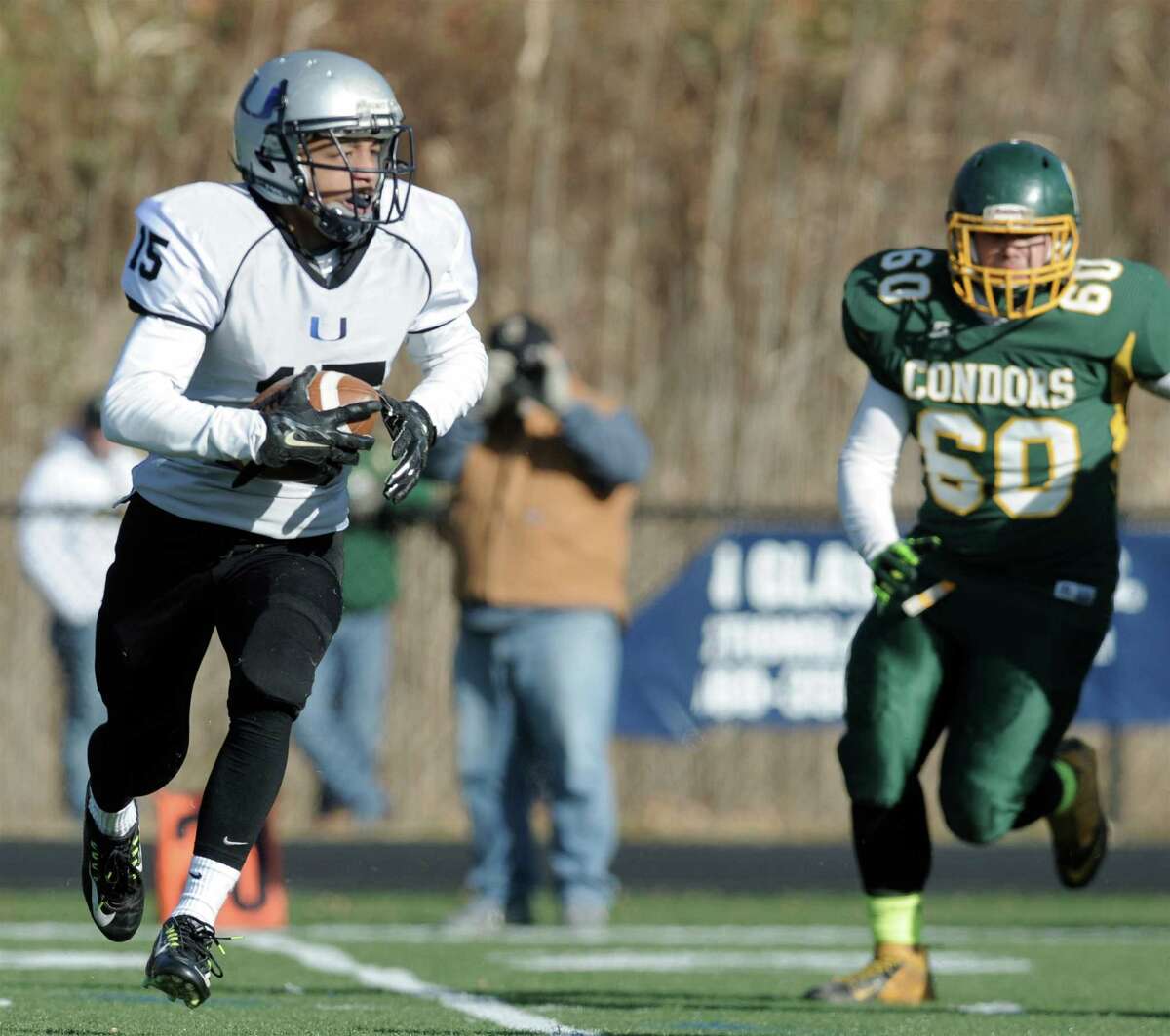 ATI United's Darius Smith (15) is pursued by O'Brien Tech's Jose Lopez (60) during the boys football game between O'Brien Tech and Abbott Tech/Immaculate United on Saturday, November 22, 2014, played at Immaculate High School, in Danbury, Conn.