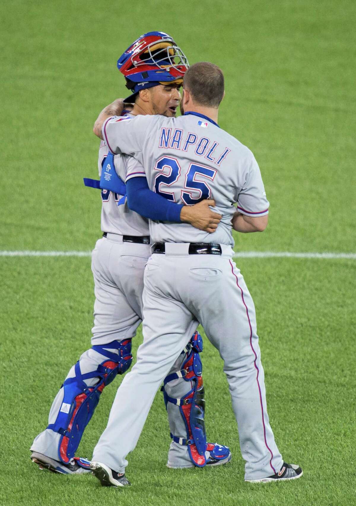 Texas Rangers Robinson Chirinos, left, and Mike Napoli celebrate their 5-3 win of Game 1 of the American League Division Series against the Toronto Blue Jays in Toronto on Thursday, Oct. 8, 2015. (Darren Calabrese/The Canadian Press via AP) MANDATORY CREDIT