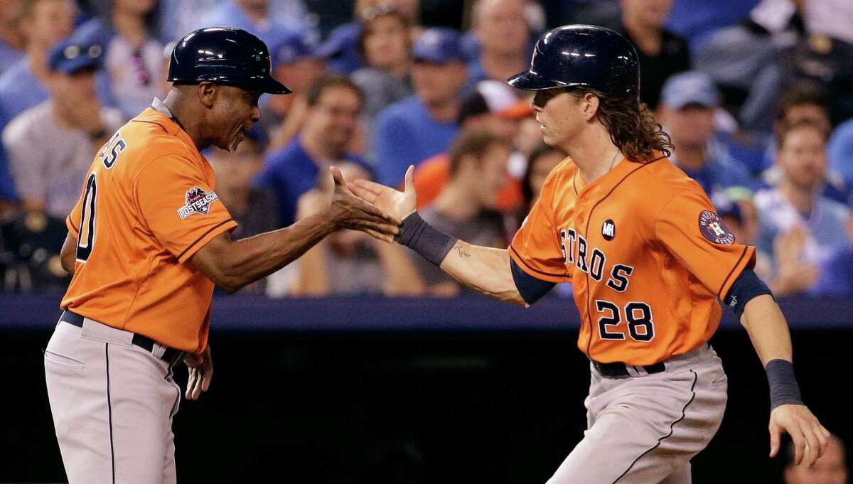 Colby Rasmus is congratulated by third-base coach Gary Pettis after a solo homer in the eighth inning gave the Astros a three-run lead they wouldn’t relinquish. Game 2 is this afternoon.