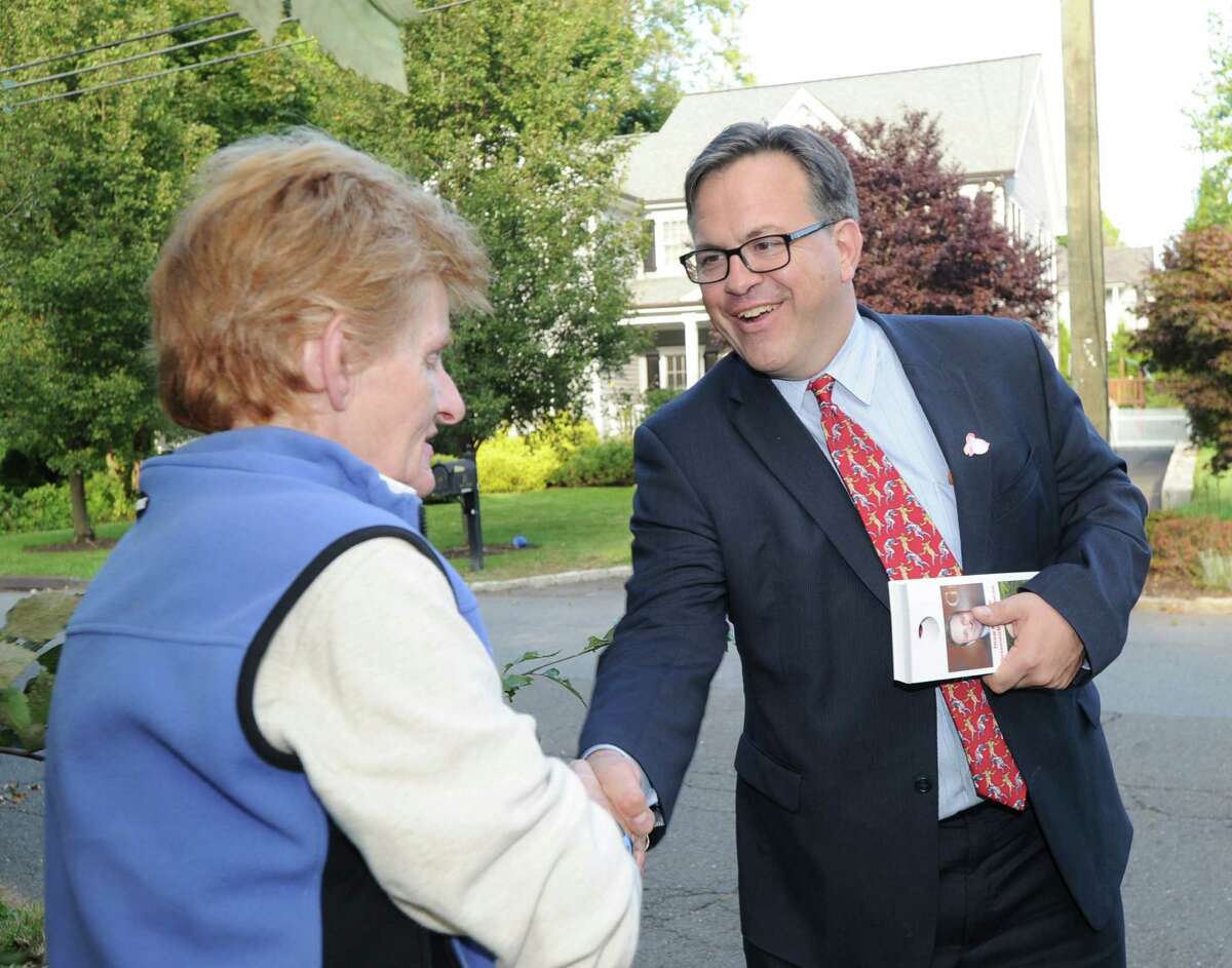At right, Frank Farricker, Democratic candidate for Greenwich first selectman, shakes hands with Meredith Sampson, while campaigning in Old Greenwich, Conn., Thursday, Oct. 8, 2015.