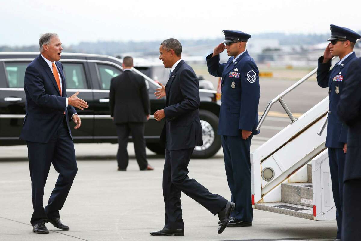 President Barack Obama is greeted by Washington Gov. Jay Inslee during a brief visit to Seattle.