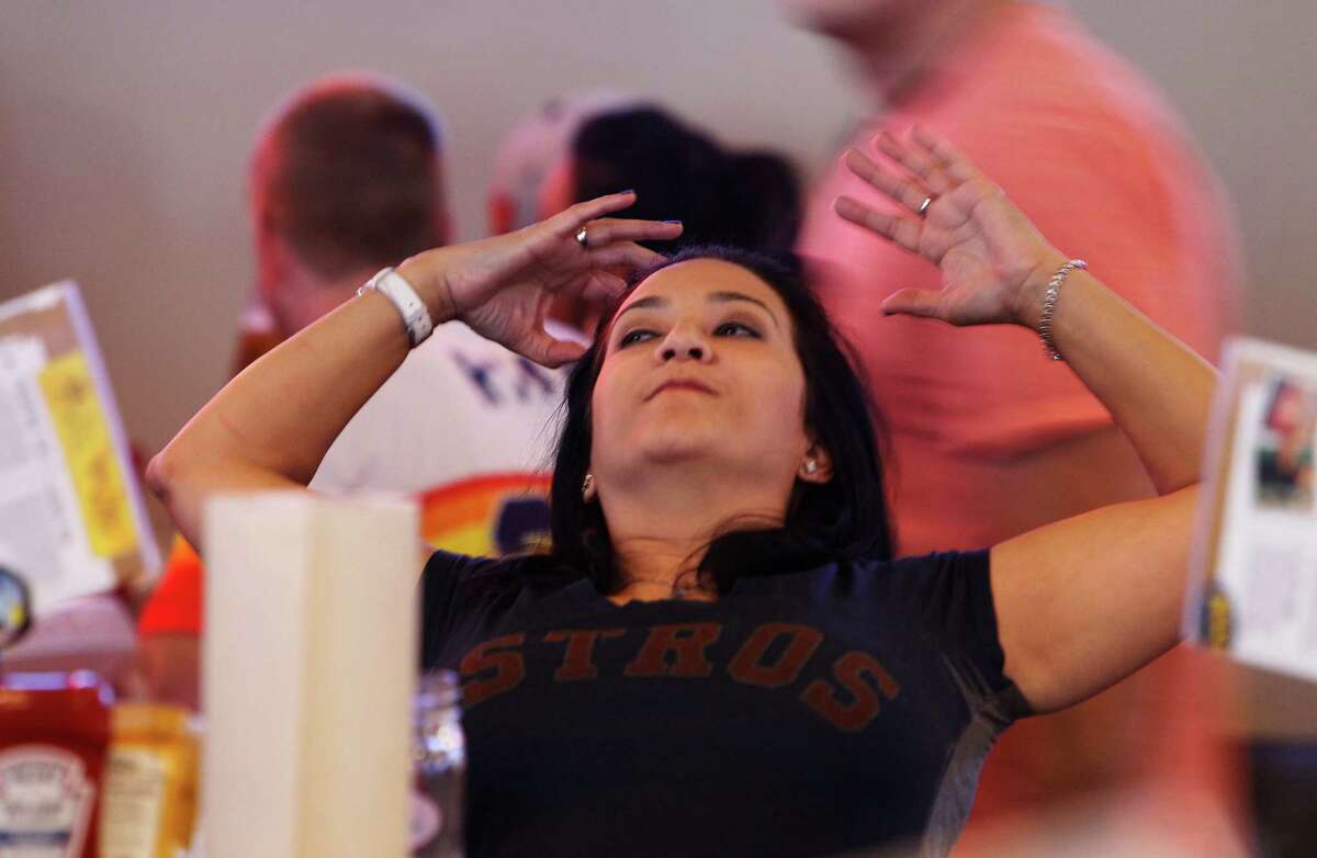 Astros fan Elvia Hernandez watches the bottom of the 7th inning.