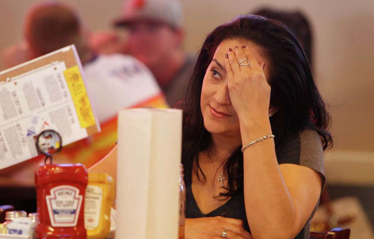 Astros fan Elvia Hernandez watches the bottom of the 7th inning.
