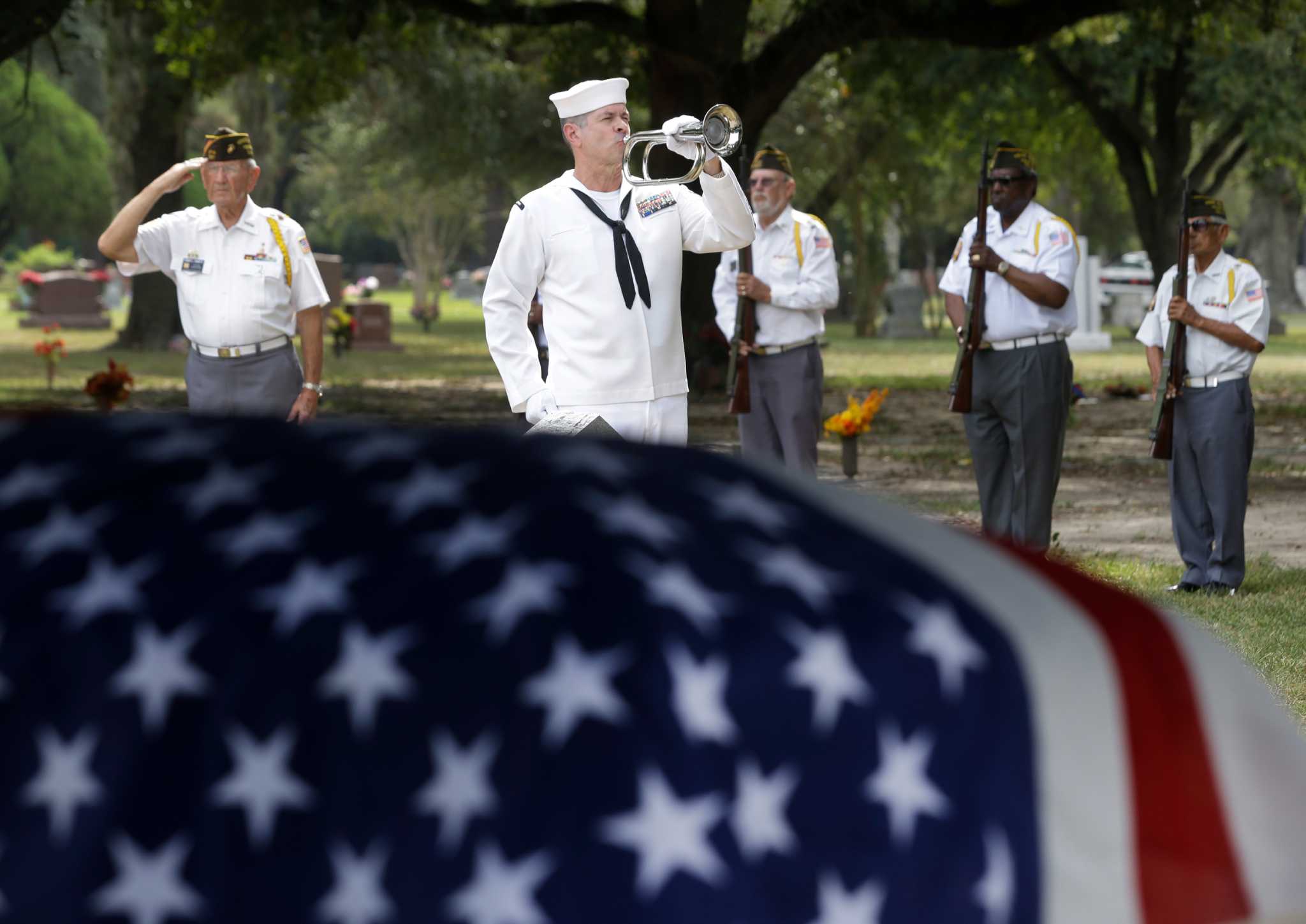 with-a-mournful-tune-a-folded-flag-a-houston-warrior-is-laid-to-rest