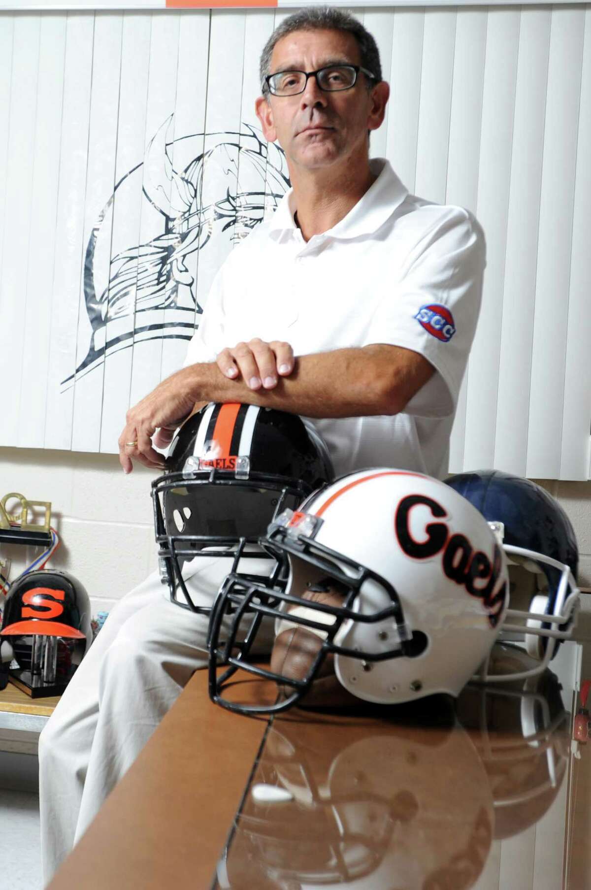 Shelton High School athletic director John Niski poses for a photograph in his office at the school in Shelton, Conn.
