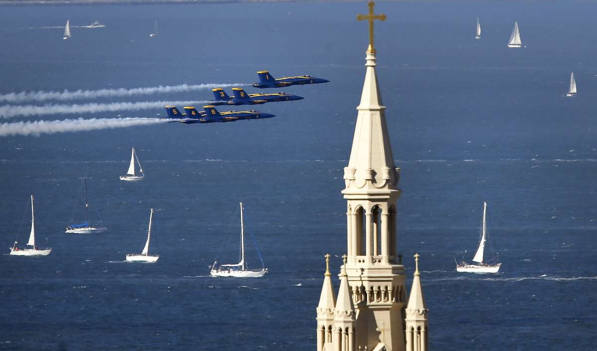 The Navy Blue Angels fly past the steeple of St. Peter and Paul Church as they take to the skies over San Francisco Bay during Fleet Week in San Francisco on Sat. October 10, 2015.