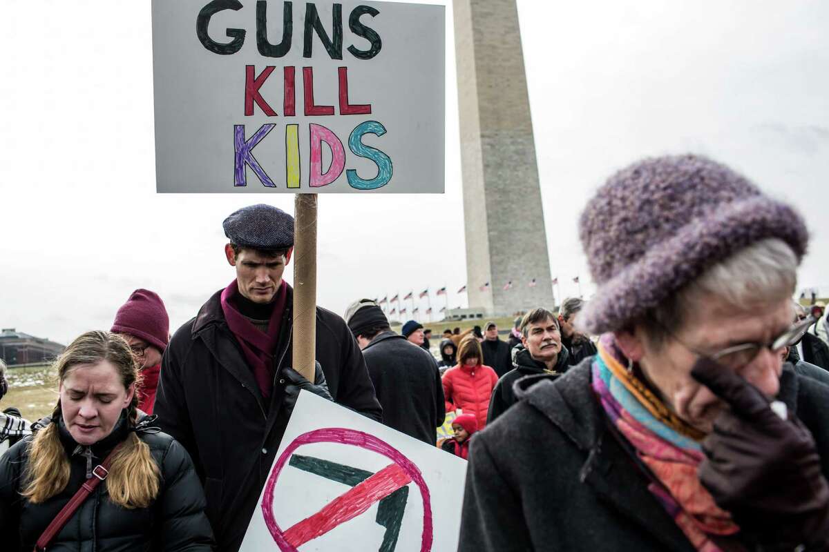 (L-R) Cori Lynn Campbell, her husband Erik Singer, both of Maplewood, New Jersey, and Martha Nichols, of Vienna Virginia, participate in a rally on the National Mall for stricter gun control laws on January 26, 2013 in Washington, DC. Demonstrators included survivors of the shooting at Virginia Tech, Newtown, Connecticut, and others. (Photo by Brendan Hoffman/Getty Images)
