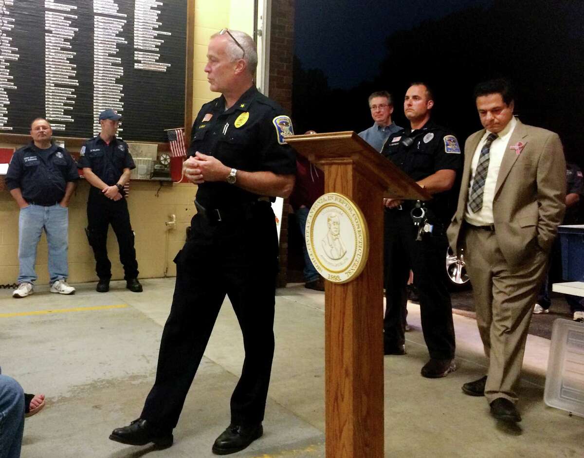 Ansonia Police Chief Kevin Hale discusses the formation of a Hilltop Block Watch at a meeting at Hilltop Hose Company on Thursday. In the background are Vinnie Scarlata, the Hilltop watch commander; Police Officer Rick Esposito and Mayor David Cassetti.
