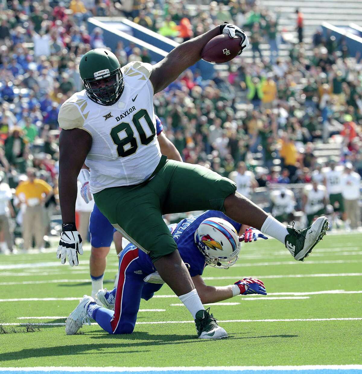 Baylor's 410-pound LaQuan McGowan gets in on the fun by rambling past Kansas' 173-pound Michael Glatczak on a touchdown reception in the first half.
