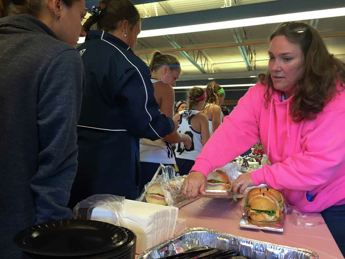 A volunteer prepares sandwiches at the Play for the Cure tailgate Sunday afternoon at Western Connecticut State University. The event raises awareness of breast cancer and was started 10 years ago.