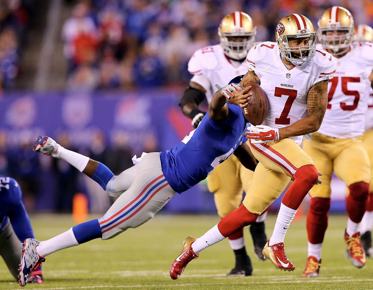 EAST RUTHERFORD, NJ - OCTOBER 11: Colin Kaepernick #7 of the San Francisco 49ers fumbles the ball as Dominique Rodgers-Cromartie #41 of the New York Giants knocks it out in the second quarter at MetLife Stadium on October 11, 2015 in East Rutherford, New Jersey.Kaepernick recovered the fumble. (Photo by Elsa/Getty Images)