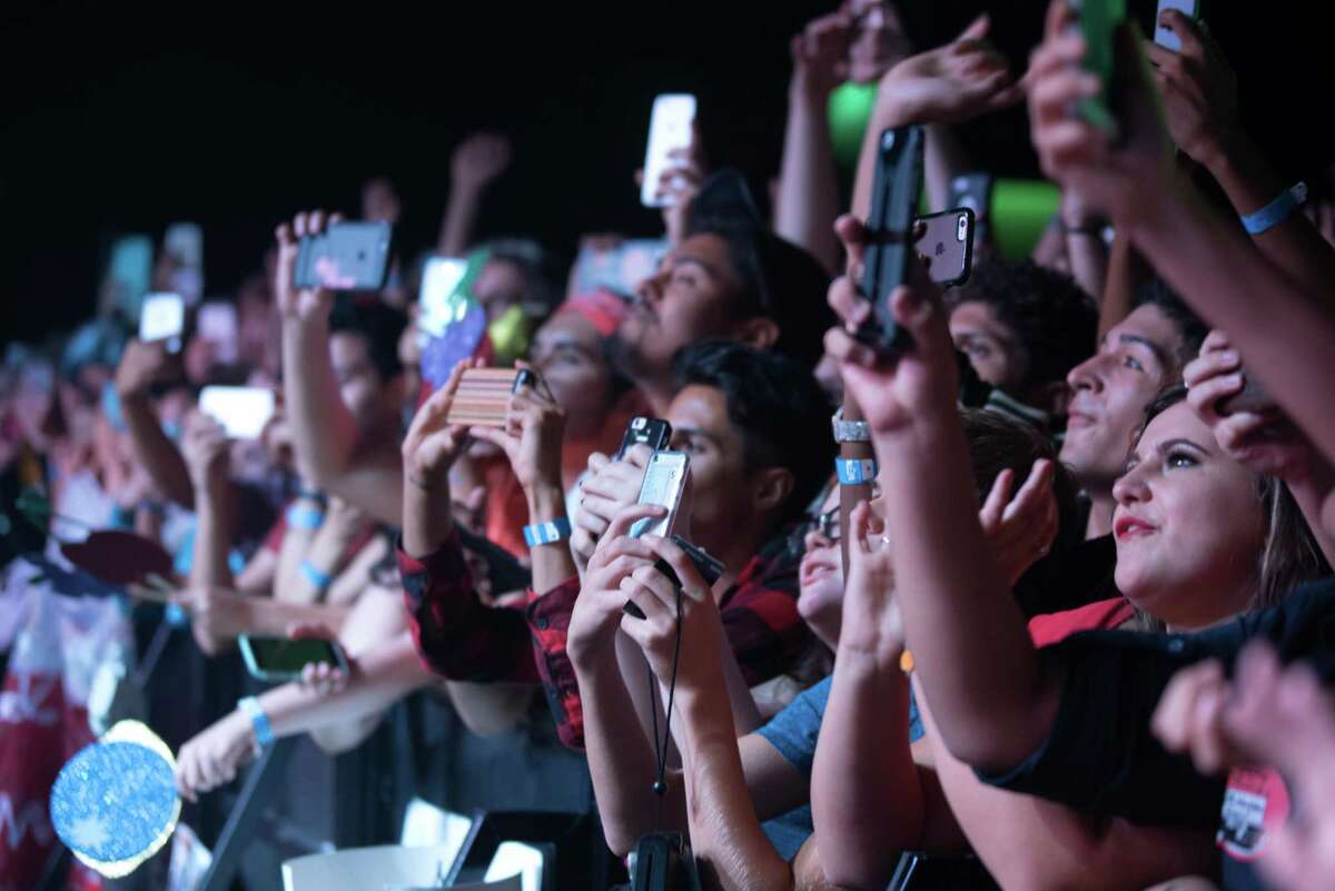 Fans record with their cell phones as Marina Diamandis, known as Marina and the Diamonds, performs at Revention Music Center in downtown Houston, Monday, October 12, 2015.