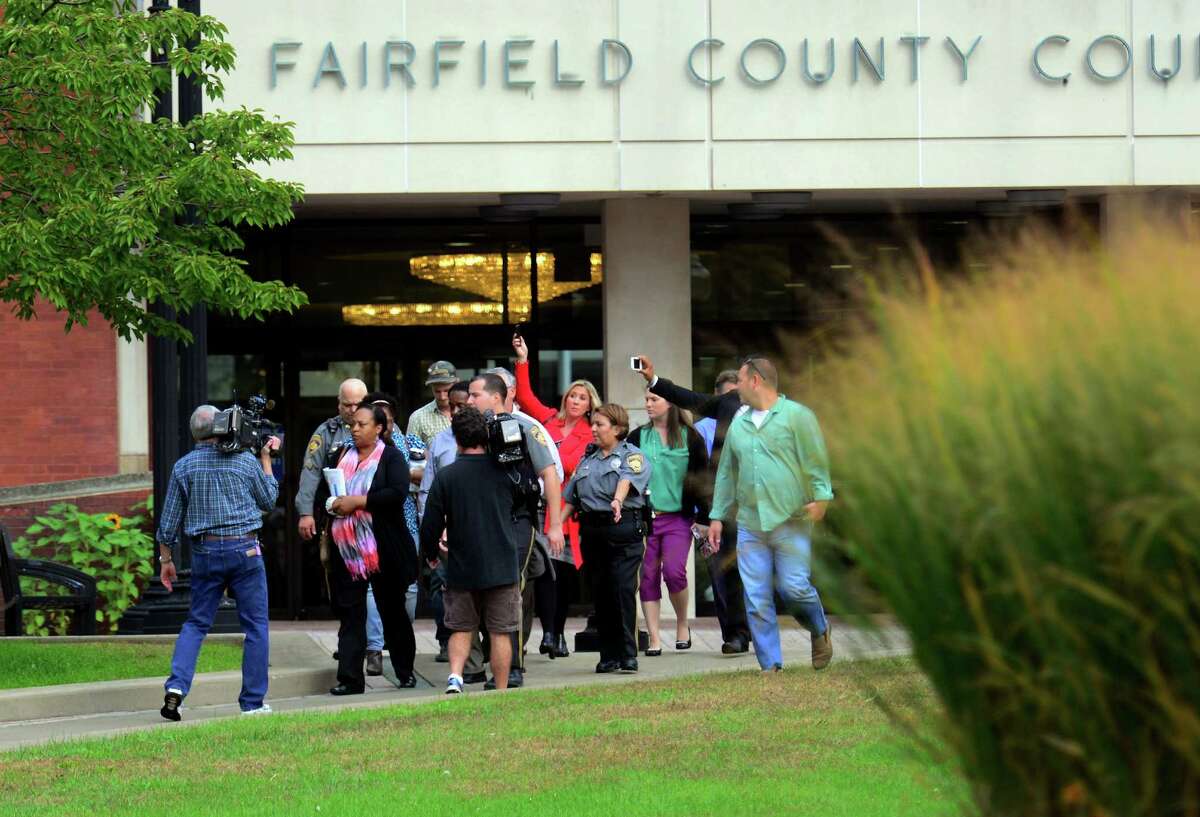 The media surround a juror after the court case involving an eight year old defendant outside of the Fairfield County Courthouse in downtown Bridgeport, Conn. on Tuesday October 13, 2015. The boy was being sued by Jennifer Connell who was injured by him four years ago.
