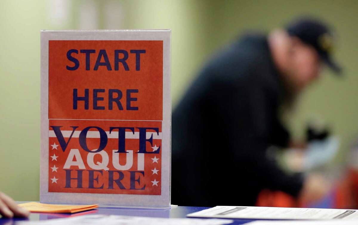 In this Feb. 26, 2014 photo, a voter prepares to cast his ballot at an early voting polling site, in Austin, Texas. (AP Photo/Eric Gay)