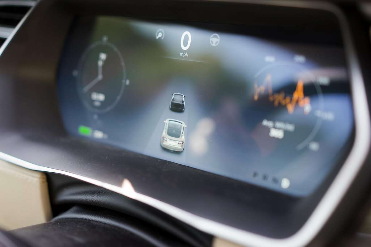 The newly upgraded instrument panel inside a Tesla detects how close it is to other vehicles during a test drive in Palo Alto, Calif. on Wednesday, Oct. 14, 2015. An update to Tesla's Autopilot system will aide drivers in changing lanes, parking and steering.