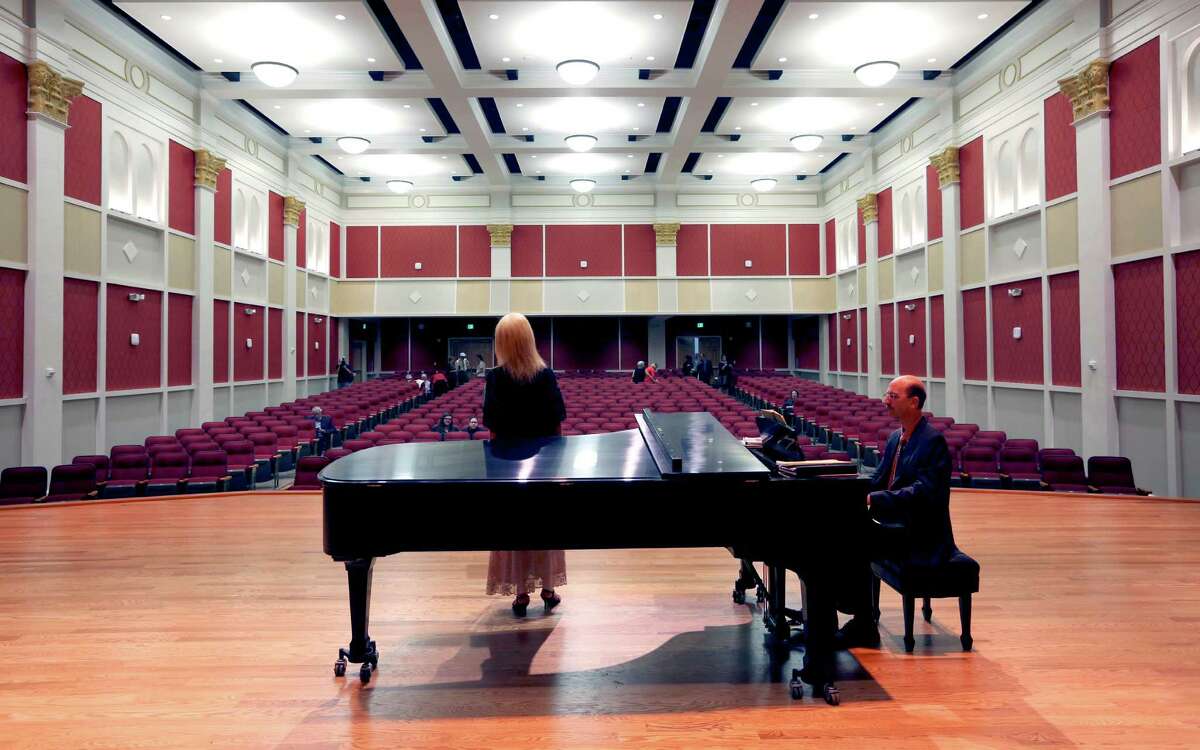 Visiting associate professor Orit Eylon sings while William Gokelman, music department chairman, accompanies her on piano in the concert hall at the University of the Incarnate Word’s new Fine Arts Complex.