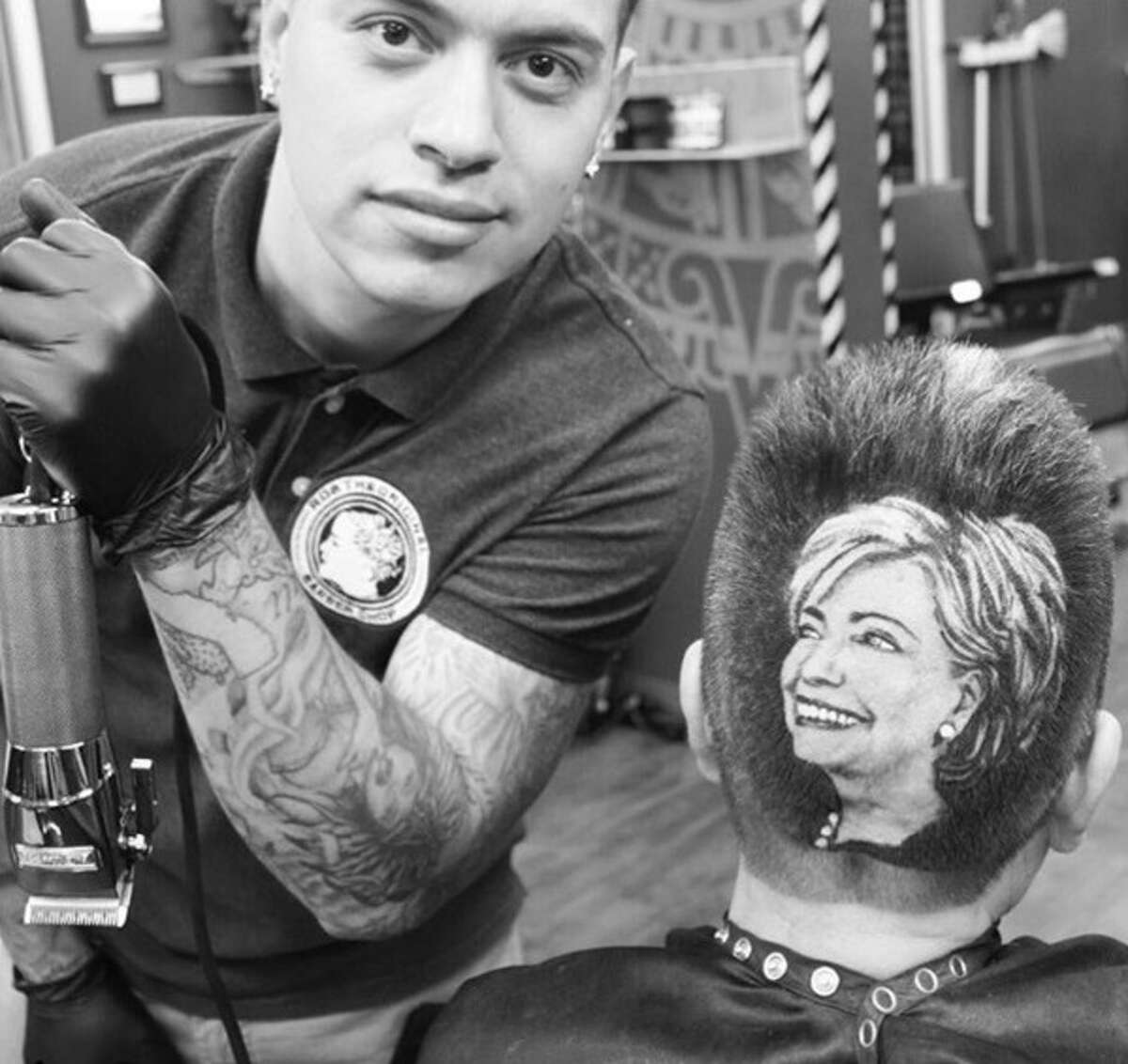 Rob the Original, a barber in San Antonio, poses next to his Hillary Clinton on October 14, 2015.