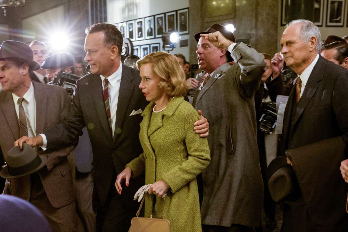 Tom Hanks, second left, Amy Ryan, center, and Alan Alda, right, appear in a scene from "Bridge of Spies."